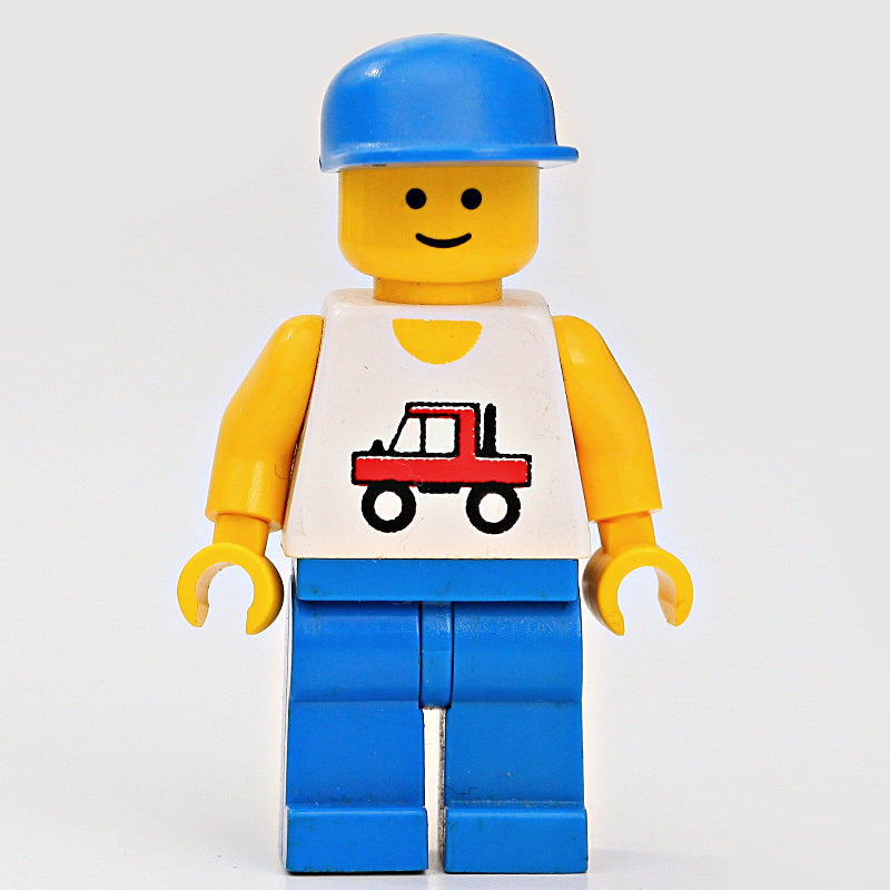 fig-000183 – Man, White Vest with Truck, Blue Legs, Blue Cap (3626a Head)
