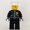 fig-000243 – Policeman, Black Jacket with Zipper, Radio, Badge, and 'POLICE' on Back, White Hat