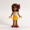 fig-000268 – Andrea - White Top, Bright Light Orange Skirt. Magenta Bow