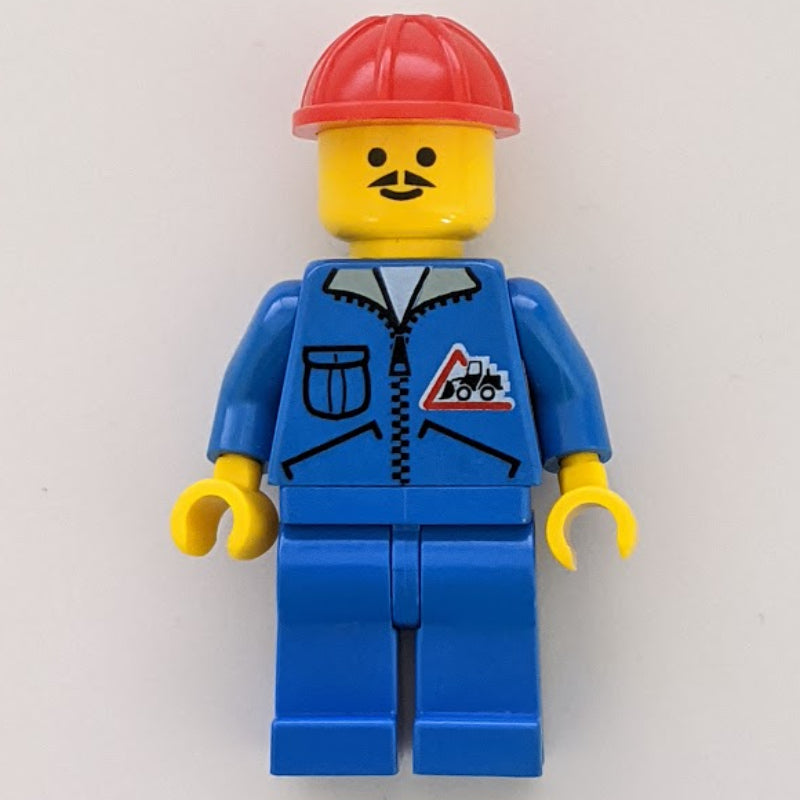 fig-000689 – Construction Worker, Blue Jacket with Zipper and Bulldozer Badge, Blue Legs, Red Hard Hat