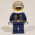 fig-001582 – Policewoman, Dark Blue Jacket with Radio, Badge, and Belt with Pouches, White Helmet with Trans-Brown Visor, Sunglasses