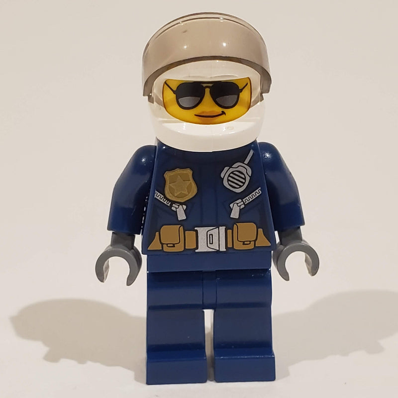 fig-001582 – Policewoman, Dark Blue Jacket with Radio, Badge, and Belt with Pouches, White Helmet with Trans-Brown Visor, Sunglasses