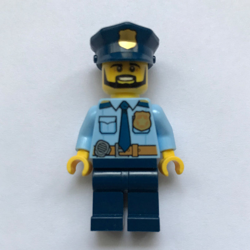 fig-001869 – Policeman, Bright Light Blue Shirt with Radio and Badge, Dark Blue Legs, Police Hat with Badge, Beard