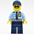 fig-001924 – Policeman, Bright Light Blue Shirt with Dark Blue Tie, Badge, and Radio on Belt, Dark Blue Cap, Sunglasses