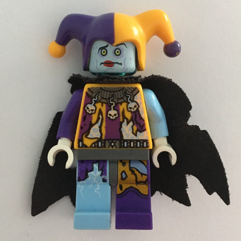 fig-003103 – Jestro in Bright Light Orange and Dark Purple Outfit with Tattered Cape
