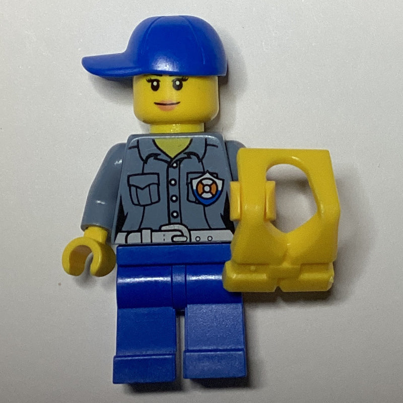 fig-007272 – Coast Guard, Woman, Sand Blue Shirt with Badge, Blue Cap, Yellow Life Vest