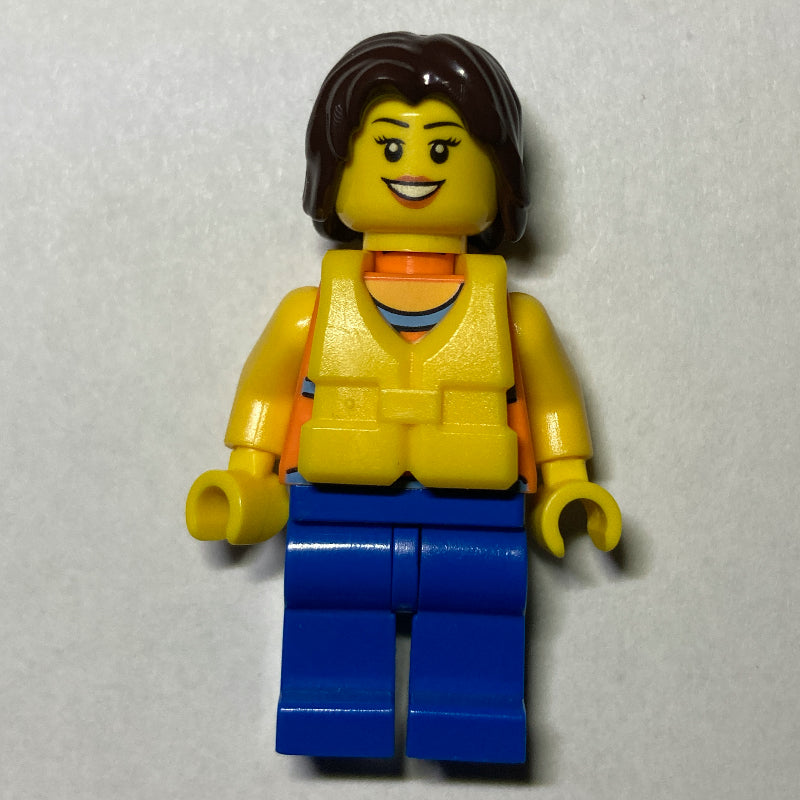 fig-007291 – Woman, Orange Halter Top with Flowers, Blue Legs, Yellow Life Vest, Dark Brown Hair
