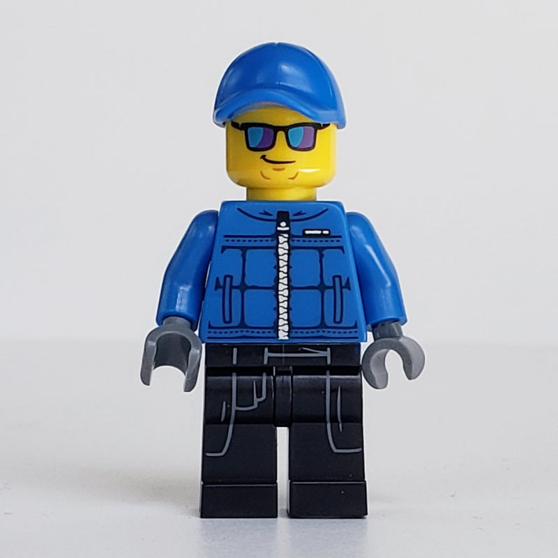 fig-007470 – Policeman, Blue Jacket with Zipper, Blue Cap, Blue and Purple Sunglasses