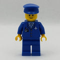 fig-007712 – Pilot, Blue Jacket with Plane Logo and Blue Tie, Blue Legs, Blue Hat, Smile, Reddish Brown Eyebrows