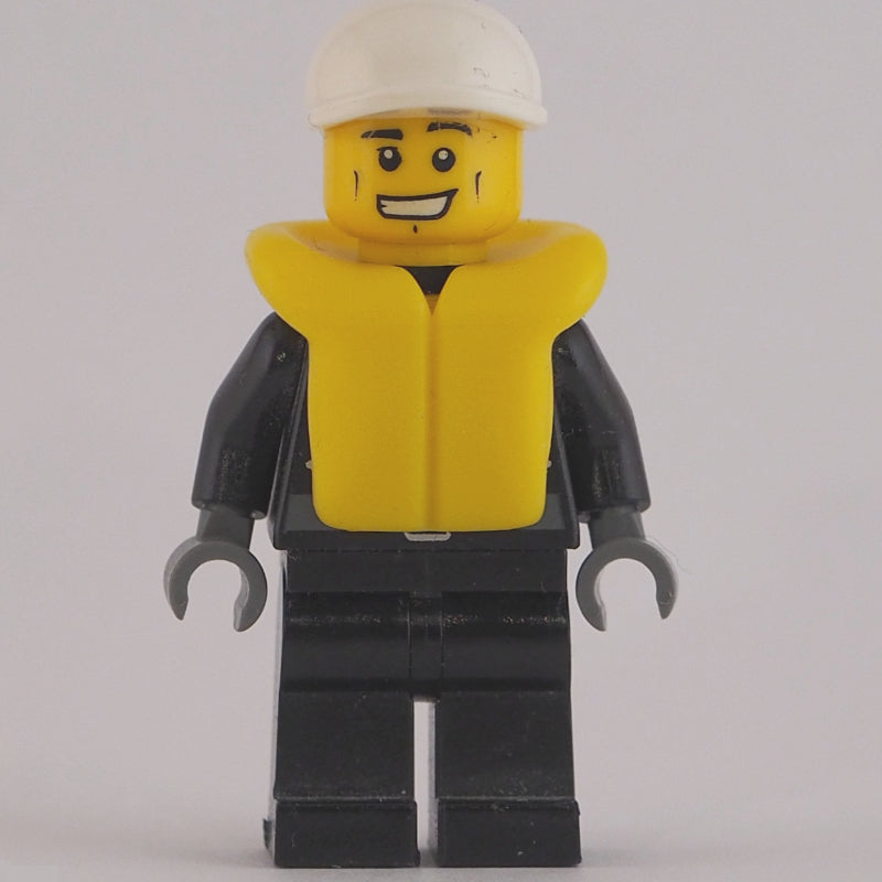 fig-007796 – Policeman, Black Jacket with Zipper, Radio, Badge, and 'POLICE' on Back, White Cap, Yellow Life Vest