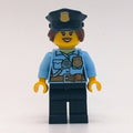 fig-007842 – Policewoman, Bright Light Blue Shirt with Radio and Badge, Dark Blue Legs, Police Hat with Badge, Open Mouth