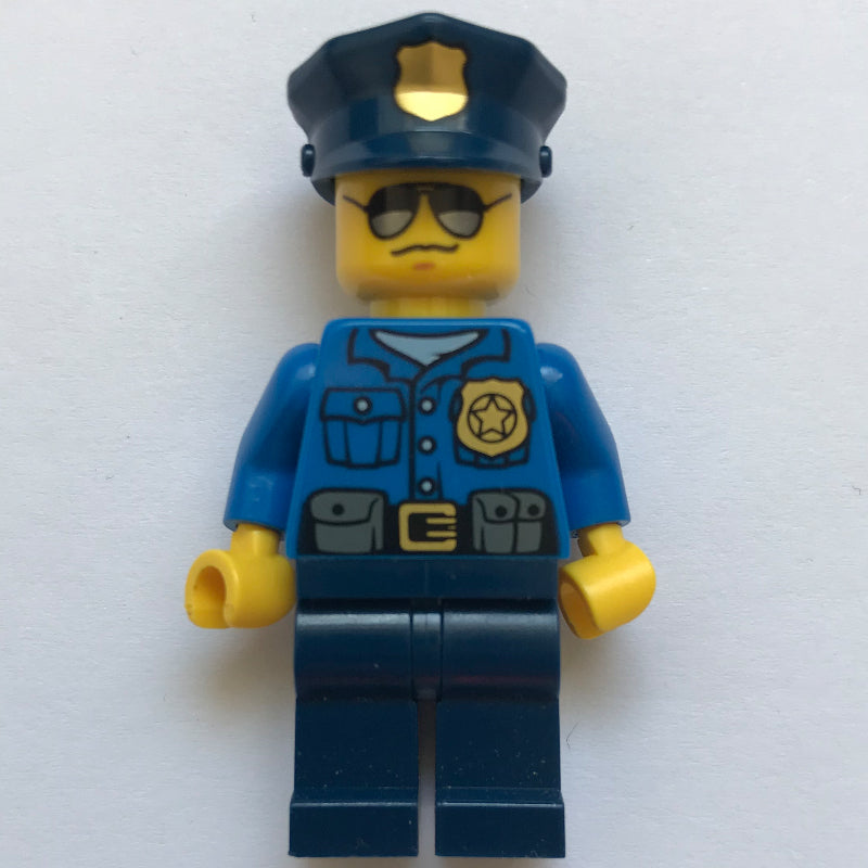 fig-007856 – Policeman, Blue Shirt with Badge and Pouches, Dark Blue Legs, Dark Blue Police Hat with Badge, Sunglasses