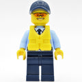 fig-007880 – Policeman, Bright Light Blue Jacket with Zipper, Radio, Badge, and Tie, Dark Blue Legs, Dark Blue Cap, Yellow Life Vest, Orange Sunglasses