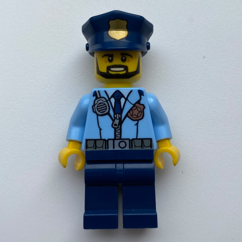 fig-007903 – Policeman, Bright Light Blue Jacket with Zipper, Radio, Badge, and Tie, Dark Blue Legs, Dark Blue Police Hat with Badge, Beard