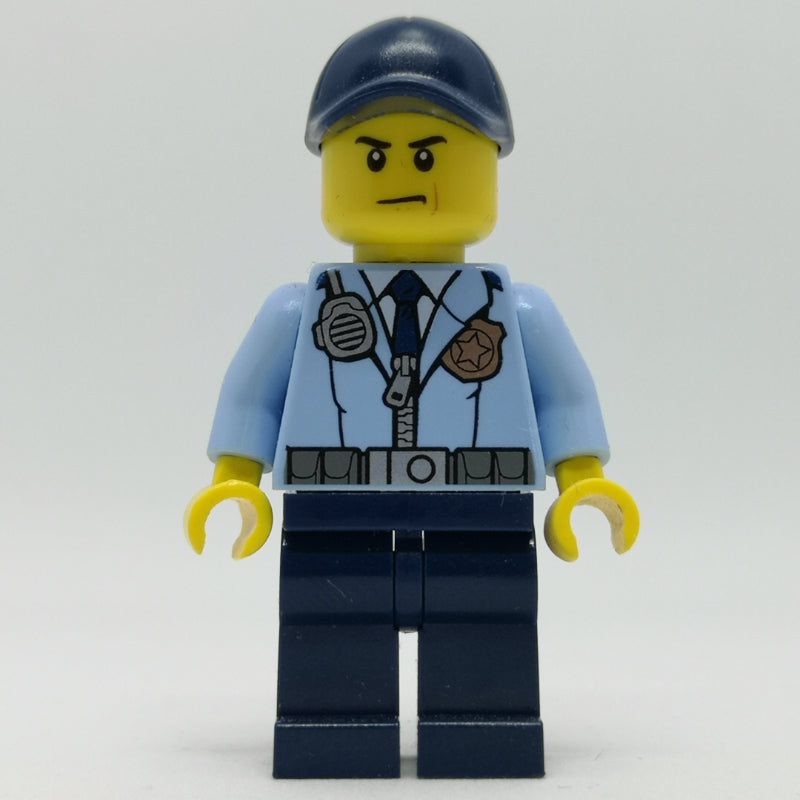 fig-007907 – Policeman, Bright Light Blue Jacket with Zipper, Radio, Badge, and Tie, Dark Blue Legs, Dark Blue Cap