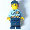 fig-007975 – Policewoman, Bright Light Blue Shirt with Radio and Badge, Dark Blue Legs, Dark Blue Cap with Hair