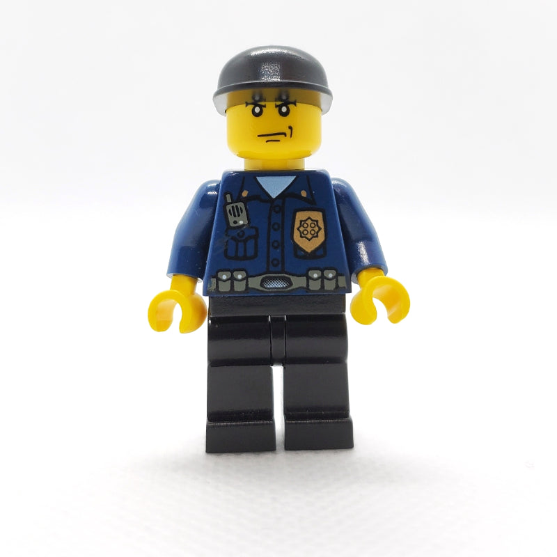 fig-008005 – Policeman, Dark Blue Shirt with Radio and Badge, Black Legs, Black Cap