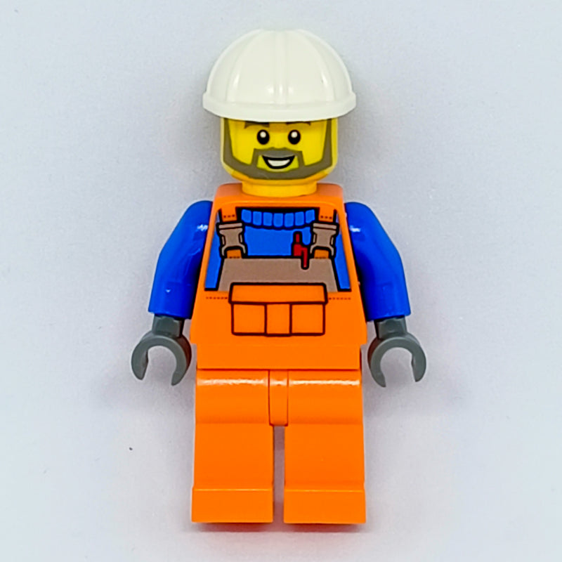fig-008100 – Construction Worker, Orange Overalls over Blue Sweater, White Hard Hat, Beard