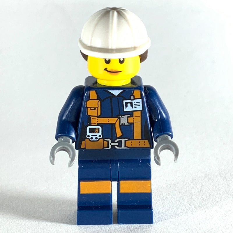 fig-008289 – Miner, Woman, Dark Blue Jacket with Straps and ID Badge, White Hard Hat with Hair, Smirk