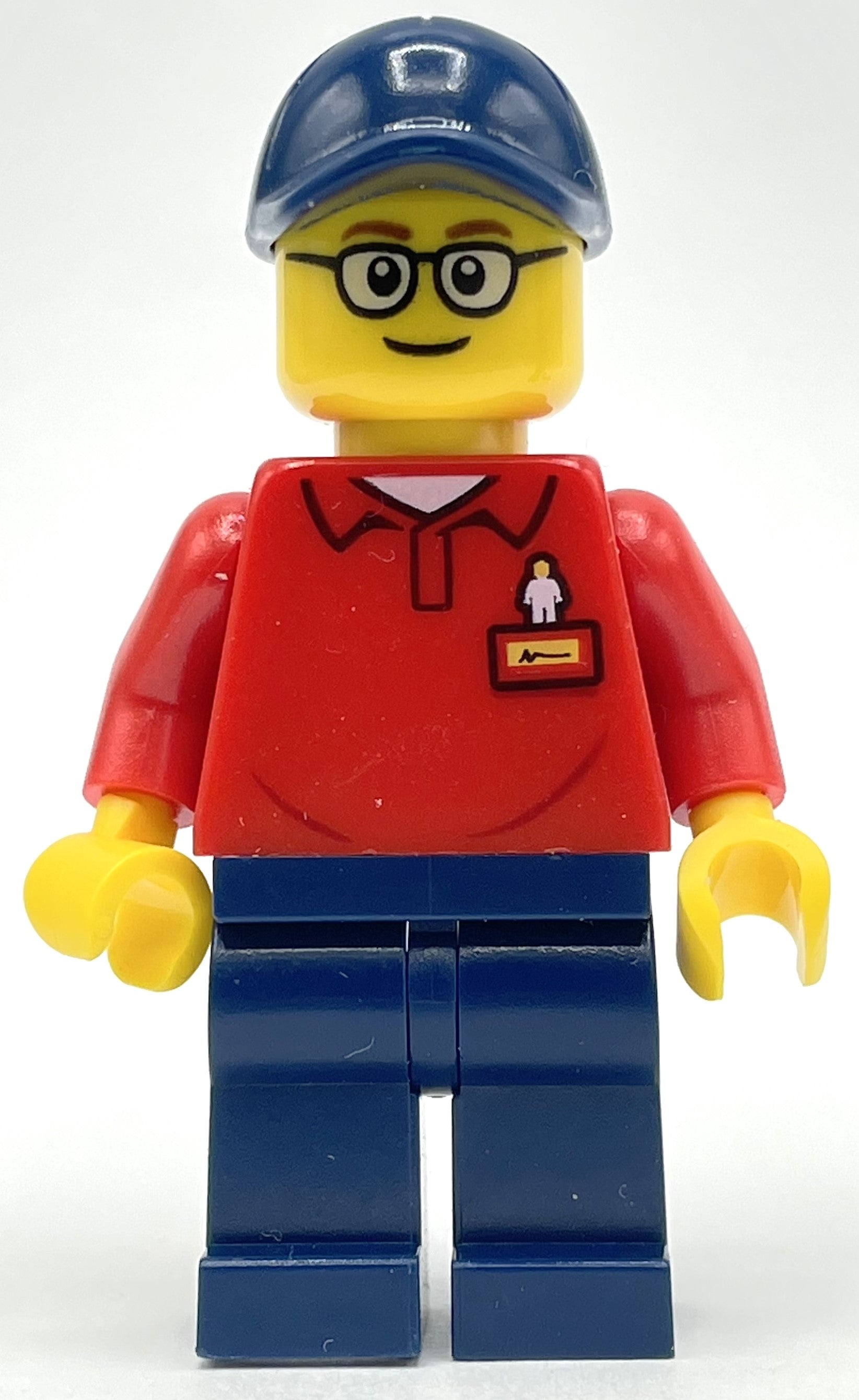 fig-008448 – LEGOLAND Employee, Red Torso, Dark Blue Legs, Dark Blue Cap, Glasses
