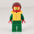 fig-008572 – Racer, Green Jacket with Zipper and Octan Logo, Red Helmet with Visor, Yellow Life Vest