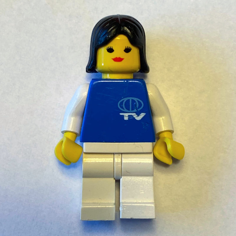 fig-008719 – Woman, Blue Top with TV Logo, White Legs, Black Hair