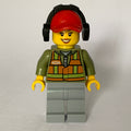 fig-009287 – Train Worker, Woman, Orange Safety Vest with Train Logo over Olive Green Hoodie, Light Bluish Gray Legs, Red Cap with Ear Defenders
