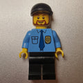 fig-009297 – Policeman, Medium Blue Shirt with Badge and Tie, Black Cap, Beard