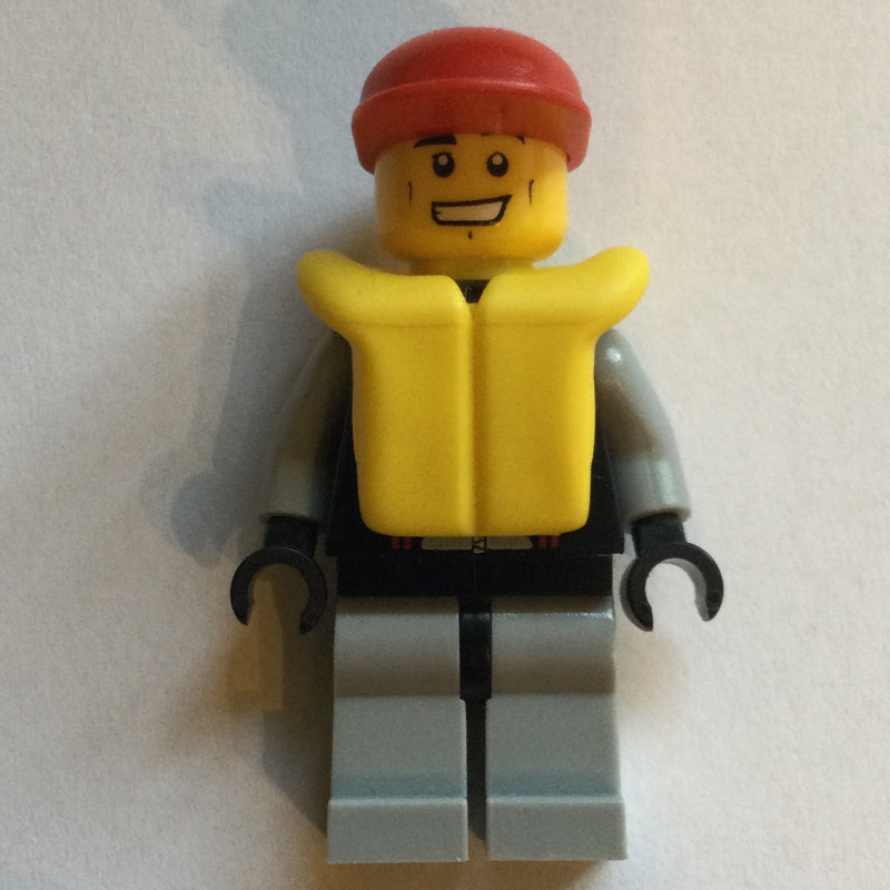 fig-009602 – Lifeguard, Black and Gray Wetsuit, Red Cap, Yellow Life Vest