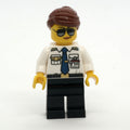 fig-009659 – Pilot, Woman, White Shirt with Tie and Wings Badge, Black Legs, Reddish Brown Hair, Sunglasses