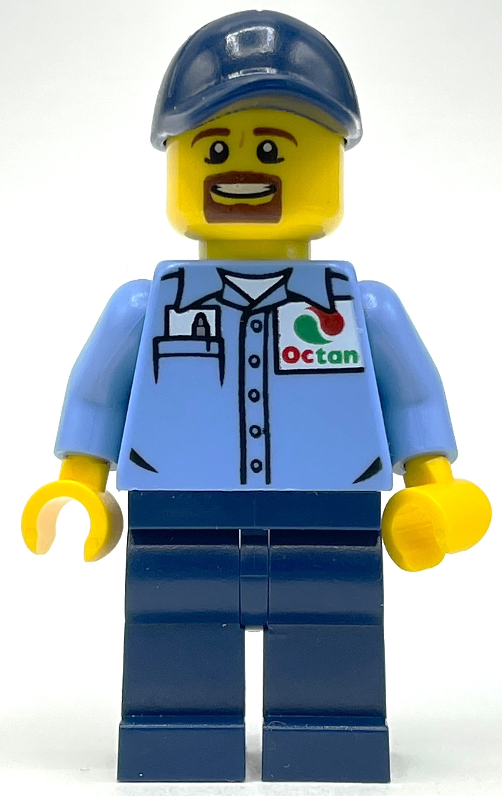 fig-009722 – Man, Medium Blue Shirt with Octan Logo, Dark Blue Legs, Dark Blue Cap, Goatee Beard