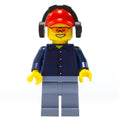 fig-009774 – Lumberjack, Dark Blue Plaid Shirt, Sand Blue Legs, Red Cap with Ear Defenders, Orange Safety Glasses