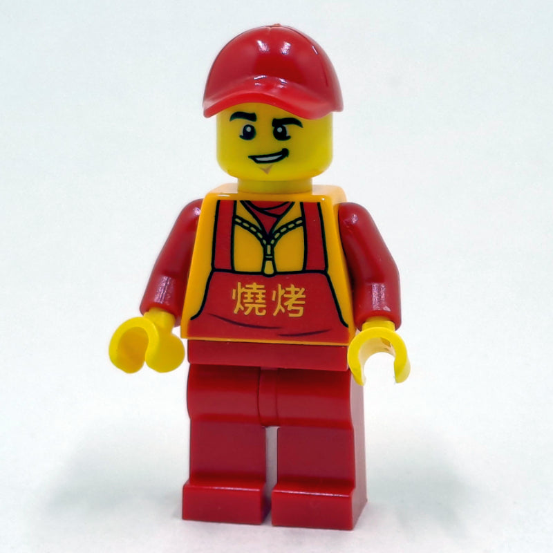 fig-009971 – Man, Red Apron over Bright Light Orange Jacket, Red Legs, Red Cap