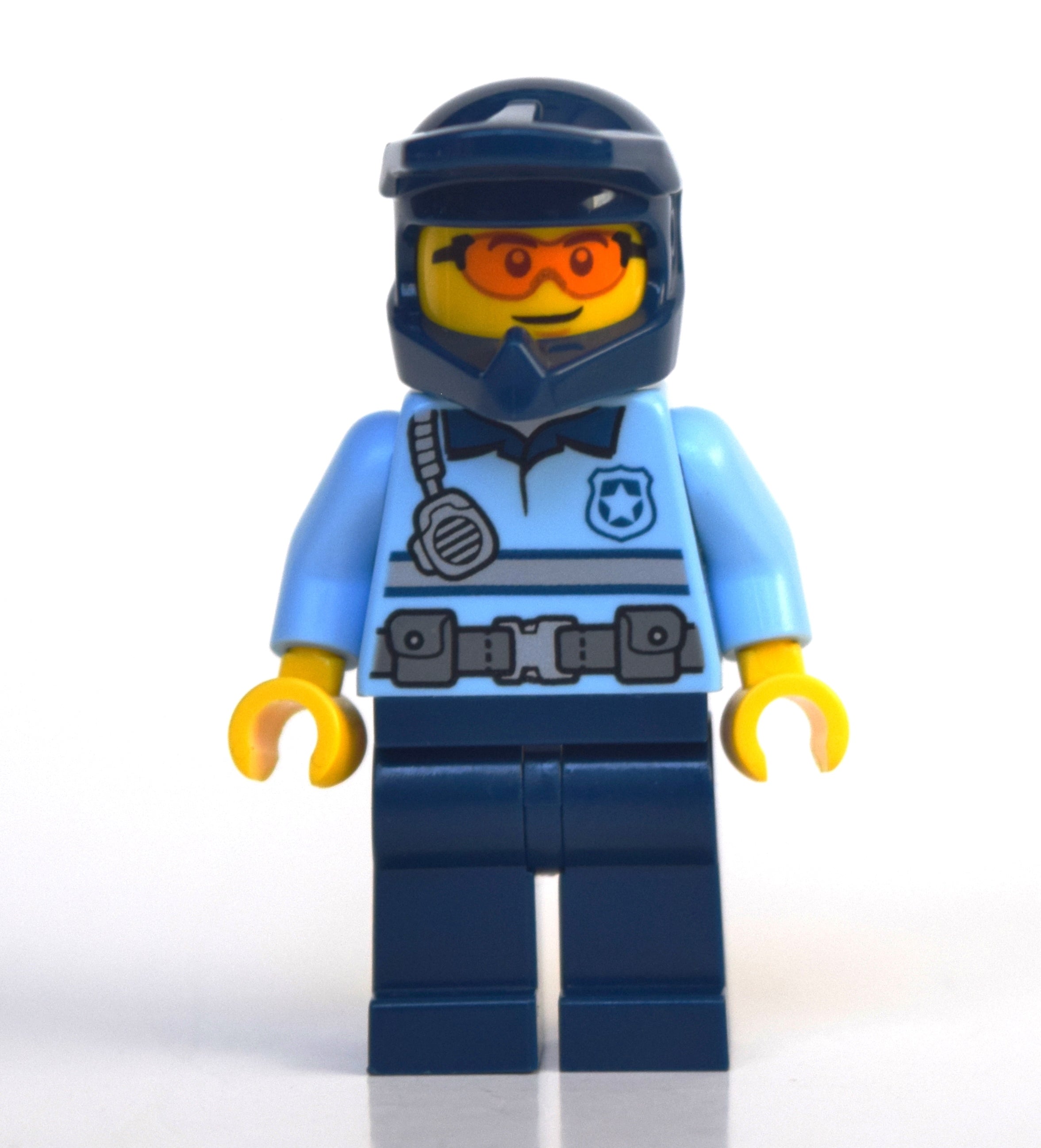 fig-010784 – Policeman, Polo Shirt with Belt and Radio, Dark Blue Legs, Dark Blue Dirt Bike Helmet, Orange Glasses