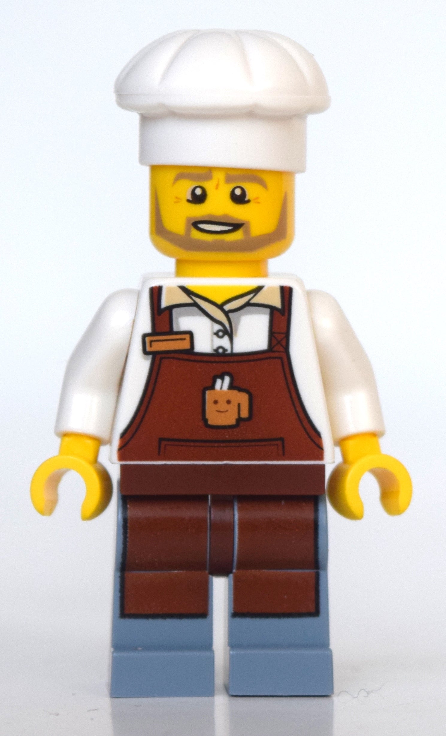 fig-010796 – Barista, Reddish Brown Apron, Sand Blue Legs, Chef Hat