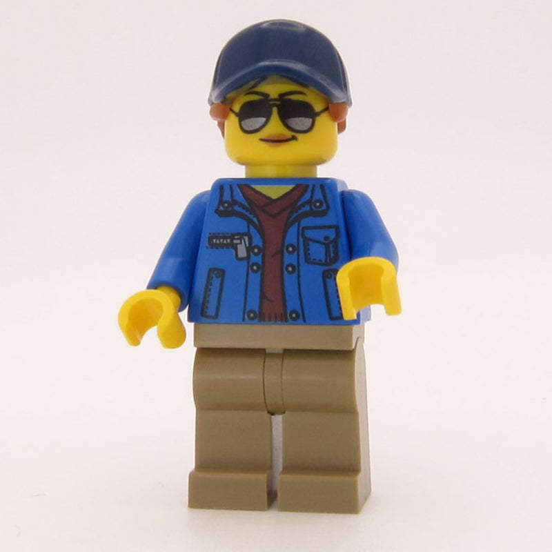 fig-010815 – Woman, Blue Jacket, Dark Tan Legs, Dark Blue Cap with Ponytail