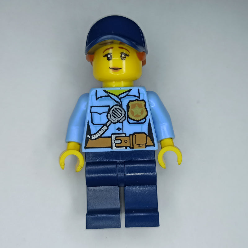 fig-010850 – Policewoman, Bright Light Blue Shirt, Dark Blue Legs, Dark Blue Cap with Ponytail