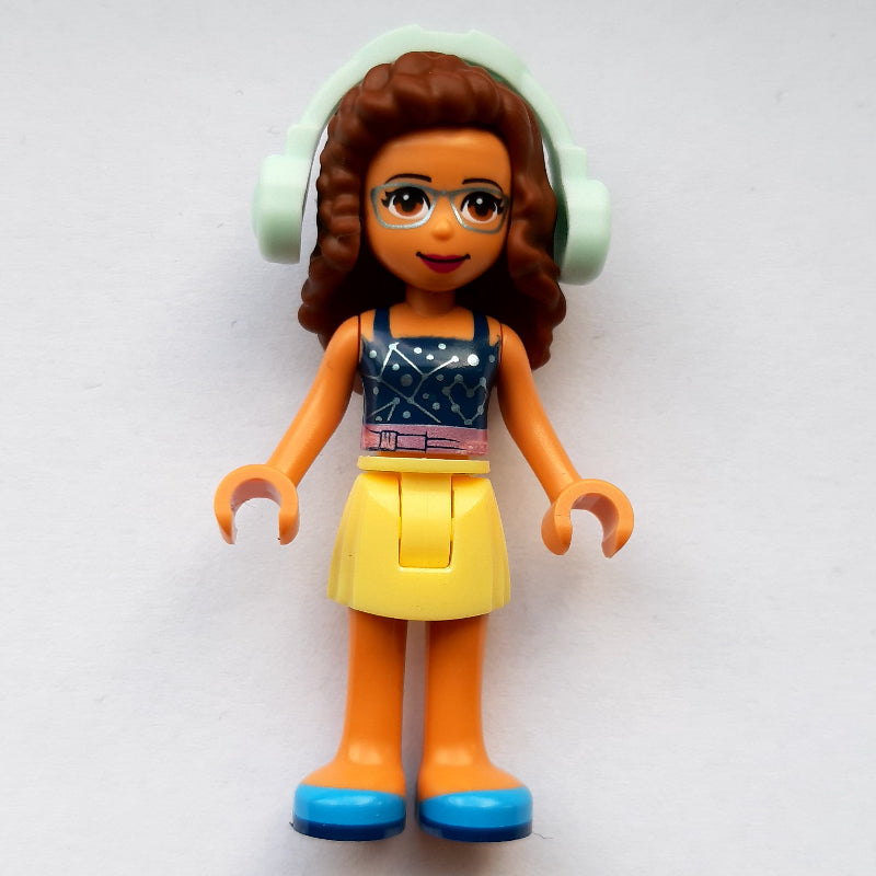 fig-011386 – Olivia - Dark Blue Top, Bright Light Yellow Skirt, Light Aqua Headphones