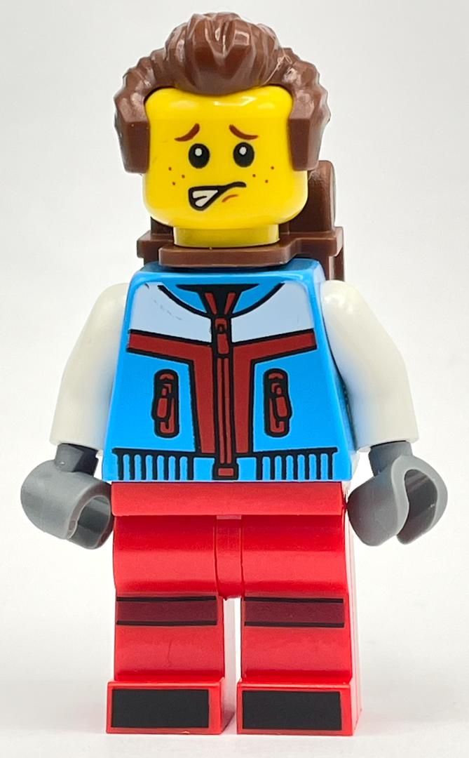 fig-014387 – Skier, Azure and Red Suit, Reddish Brown Backpack and Hair